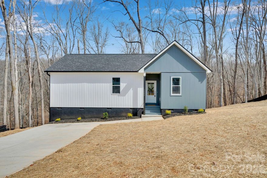 Immaculate new construction in the sought after Spring Shore community, just moments from Lake Norman and an easy drive to Statesville and Mooresville. This inviting 3 bedroom, 2 bath, single story home offers a little over 1,200 square feet of thoughtfully designed living space with modern curb appeal, featuring a board-and-batten exterior paired with engineered wood accents for a warm, upscale look. Inside, the open-concept layout maximizes every square foot, with a comfortable living area that flows seamlessly into the kitchen and dining space—perfect for everyday living and casual entertaining. The split-bedroom plan provides privacy for the primary suite while keeping secondary bedrooms convenient for guests, kids, or a home office. Located in Spring Shore, you’re in an established Iredell County neighborhood known for its peaceful atmosphere, larger lots, and proximity to Lake Norman recreation, shopping, dining, and commuter routes. This is a rare chance to own a low-maintenance, one-level home in a lake-area community—ready for you to move in and start enjoying the lifestyle. The neighborhood features a community boat ramp, dock with day slips, picnic area, and seasonal lake views!