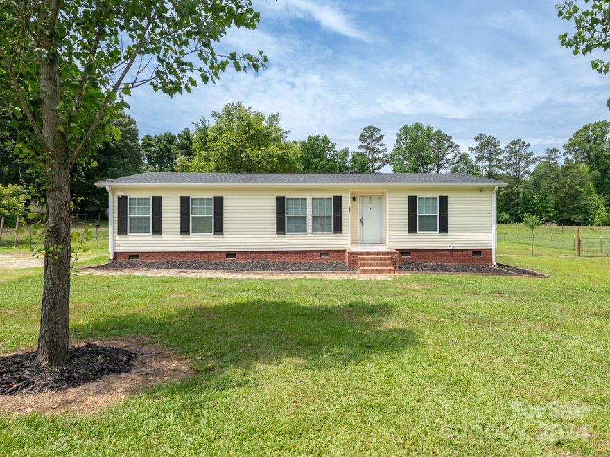 Experience the epitome of serene country living in this exquisite 3-bedroom, 2-bathroom home, ideally positioned on 2.36 acres within the highly sought-after Buford School District. The master bathroom features dual vanities, a spacious garden tub, and a separate shower. The HVAC system and roof are both approximately three years old. The home boasts hardwood floors, a spacious kitchen and dining area, and walk-in closets. The expansive yard offers ample space for a dream garden and includes a substantial 6-stall barn. Additional features include a fenced yard, a large covered deck, and abundant privacy. Tax Map 0058-00-056.02 is included, with the benefits of no city taxes and no restrictions.