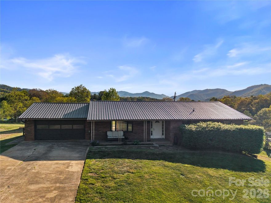 Enjoy peaceful country living without sacrificing convenience in this unrestricted mini farm, ideally located just minutes from shopping, dining, and everyday amenities. 

Set on 5.08 scenic acres, the property features open pasture, beautiful views, and space for all your livestock, complete with a barn, chicken house, and fenced areas near the home.

The charming 3-bedroom, 2-bath brick home offers hardwood floors, a cozy country kitchen, and a spacious dining area with a wood stove. A bright living room with a picture window brings the outdoors in, while the main level includes a primary suite and updated baths. The finished lower level adds a large rec room, bonus room with barn doors, and a full bath with soaking tub.

Outside, the property is thoughtfully equipped for both function and enjoyment. Approximately 2 acres near the home are fenced and ready with a barn and chicken house, while an additional adjoining 2.9-acre cleared lot offers endless possibilities from expansion to building or simply soaking in the views. Easy, level access, an attached two-car garage, a detached two-car garage, and an RV hookup complete this rare offering.