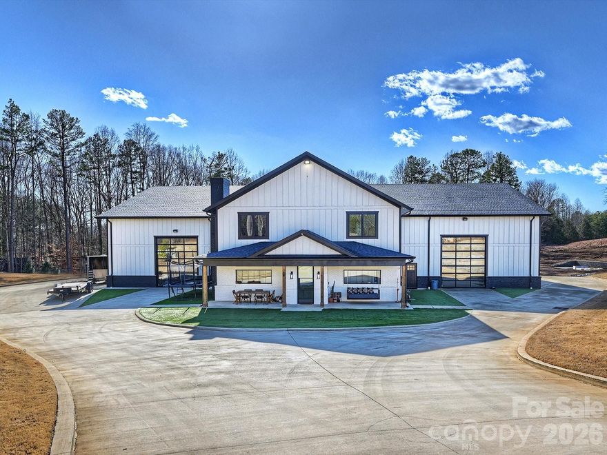 Experience the pinnacle of privacy and adventure in this nearly 15,000 sq ft custom barndominium estate, set on nearly 14 acres. Thoughtfully designed for automotive collectors, off-roading enthusiasts, and those seeking space to live boldly, the residence features two fully independent living quarters—each with its own kitchen and living area—and 4 generous bedrooms, perfect for guests or multi-generational living. Enjoy the convenience of private fuel storage, underground garages, and a secure gated entrance. Outdoors, unwind beside the resort-style saltwater pool framed by elegant turf. Host unforgettable gatherings in your private bar and club room, or embrace your adventurous side with a rock climbing wall, basketball court, and expansive acreage to explore nature. Horse stalls and wash bay open this property up for a great equestrian property or hobby farm! This estate offers unparalleled luxury and freedom—where adventure meets elegance, and your dreams become reality. Total acreage is on this parcel of land is just over 35. Attached survey shows parcel split into 2 lots. This listing is for Lot 1 that is roughly 13.75 acres and includes the barndominium. Also see MLS #4249385 for 35+ acres and MLS #4376403 for lot 2, which is roughly 21.47 acres. Seller also open to moving the subdivision line to offer more/less acreage for either lot, as long as acreage doesn't drop under 10 on either lot. Call listing agent for more details. Both lots currently share a gated entrance. Would need to be divided upon closing of either lot unless all purchased together.