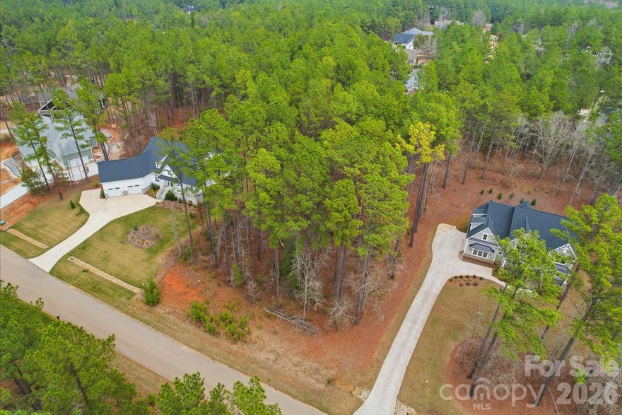 Build your dream home in one of the Charlotte region’s best-kept secrets — Riverchase Estates. This beautifully wooded 0.92-acre homesite sits within a private gated community along the Catawba River and offers the perfect blend of natural beauty, privacy, and resort-style amenities.

This densely wooded lot features a desirable layout, creating the ideal setting for an expansive backyard and added privacy while providing the perfect canvas to design the custom home you've always envisioned. Surrounded by mature trees and scenic natural surroundings, this homesite offers the peaceful feel of a private retreat while still being part of one of the region’s most sought-after acreage communities.

Residents of Riverchase Estates enjoy an exceptional lifestyle featuring a gated entrance, private river access, and a spectacular $4 million amenity center complete with a clubhouse, fitness center, outdoor pool, tennis and pickleball courts, playground, and scenic walking trails.

Conveniently located just minutes from Indian Land, Waxhaw, and Fort Mill, homeowners enjoy easy access to shopping, dining, grocery stores, and everyday conveniences while still coming home to the quiet beauty and privacy of this remarkable community.

With low Lancaster County taxes and the flexibility to bring the builder of your choice and build on your timeline, this homesite offers both freedom and long-term value.