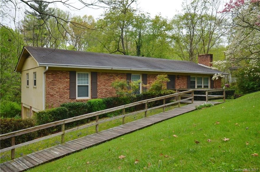 Ranch style 3 brm, 2 bath home west in Asheville from the early 70's needs updating and is being sold AS IS. It is in the Woodside Hills community of moderate sized to larger homes with large yards and mature landscaping. Features a ramp from the driveway and a full bsmt not counted in sf due to lack of finishing down. Bsmt has a family room, bath and uncarpeted bonus room. Two decks in back. Large yard space. Convenient to Buncombe soccer and athletic fields.