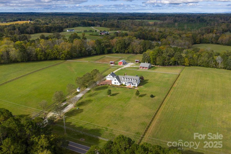 This 14.88 acre equestrian estate has been transformed by the current owners into a true equestrian estate among neighboring estates in highly desirable Davie County, offering world class healthcare, education and historic charm. The William Poole Virginia Farmhouse was just waiting for the finishing touches, the current owners accomplished including both primary bathrooms updated, kitchen, new front porch, brick motor court with newer 2 car detached garage designed to finish a 2nd floor room. Three fireplaces, crown molding, cherry hardwood floors on main floor and oak floors on the second level are just a few of the other features that enhance the home.  While the home has been renewed, the farm itself has taken on a major transformation including gated entrance, 3 board fenced perimeter fencing, 3 lush, managed pastures and manicured trails among the woods. The 4-stall barn offers brick aisleway and exterior aprons, Morton building upgrades, including glass end sliding doors, Dutch exterior doors w/yokes that open to metal bar dry paddocks that open to a smaller barn yard.  A walk-up hay loft, climate-controlled tack room with half bath, metal encapsulated wash stall and fans ensure both equestrian and horse will enjoy the immaculate environment.  Drainage systems throughout the farm ensure year-round is mud free. Two run-in sheds, one with lights and fans, a 104'x152' sand arena and 36 x 20' 3 bay equipment building ideal for tractor and trailer storage round out the well designed, safe estate.   Unload the horses and move in, it's already set up for you.