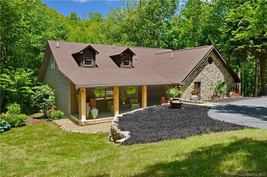 Experience tranquility at it's best at this North Carolina MOUNTAIN HOME on rushing Jonathan Creek. Fish in the back yard or entertain guests in your own Creekside Pavilion. Great Room offers open living/vaulted ceilings & huge stone fireplace. Main floor also has 2 bedrooms and 2 baths & laundry. Upper level has 2 bonus rooms, a 3rd bath, and a large loft area. Over-sized 2 car garage with paved circular drive. Beautiful stone work & meticulous landscaping. Easy access to all WNC attractions.