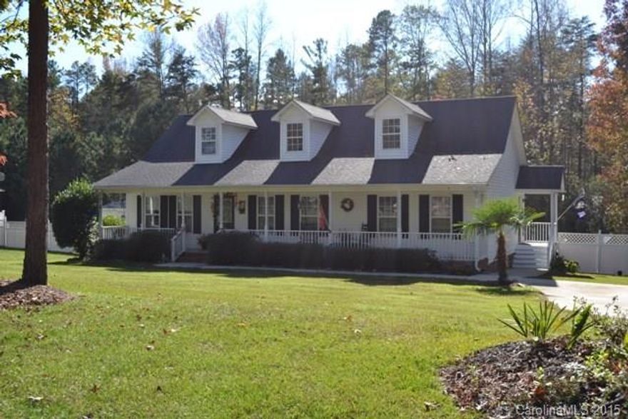 Rocking chair front porch on a huge 2.5 acre lot!  Roomy great room with beautiful hardwoods and fireplace!  Cozy kitchen with breakfast area and bar!  Large rooms and spcaious bathrooms! Privacy fencing all on sides, screened porch and deck for year round use! Nearby lake access and Waters Edge!