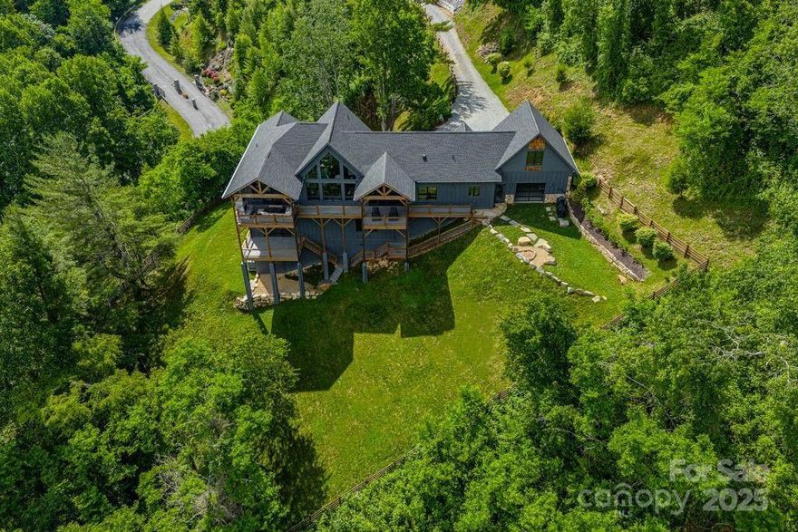 Welcome to one of Banner Elk’s most distinctive residences-modern elegance meets urban-industrial sophistication. Conceived & curated by Academy Award–winning producers, this bespoke home showcases perfect harmony between natural mountain warmth & cutting-edge design. From hand-selected local timber beams to artisan-crafted furniture, fixtures & lighting sourced from top makers across the country, every detail chosen with intention & aesthetic precision. Privately nestled at the end of a 300-ft driveway in a beautiful gated enclave, the home offers rare, uninterrupted panoramic views of the High Country completely unspoiled by neighboring rooftops-yet only 3 minutes from downtown Banner Elk & less than 10 minutes to the ski lifts. Designed as a sanctuary for both people & pets, property features nearly an acre of beautifully landscaped grounds wrapped in a discreet privacy fence—creating the ultimate off-leash haven for your dogs to roam freely. Luxury meets function in every room.