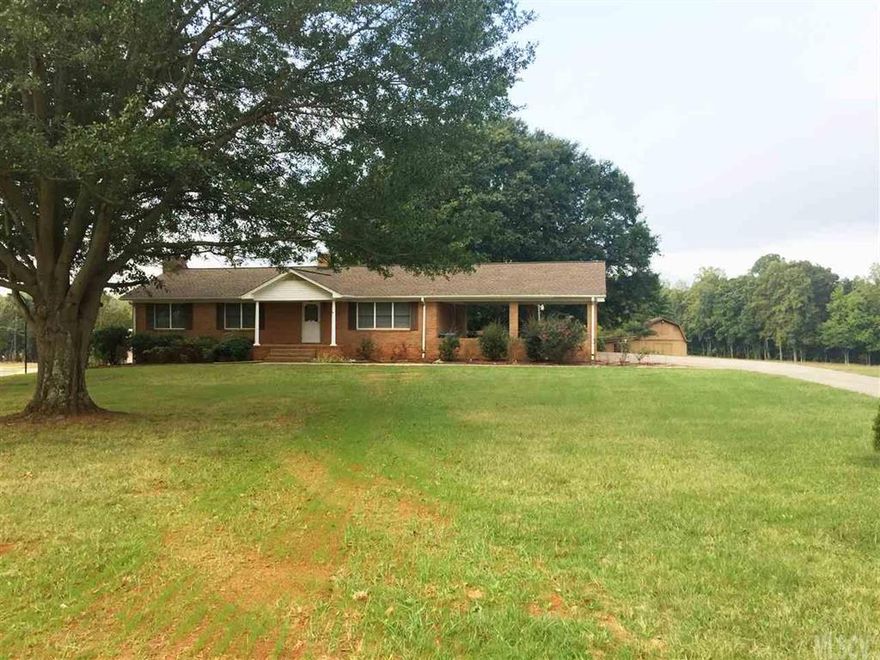 Sprawling All-Brick Ranch with Full Basement on 2.21 Acres!  This home features: Updated Kitchen w/ Refrigerator, Range, Microwave, Dishwasher, Disposal, Island/Breakfast Bar, Serving Bar and Tons of Cabinets; Eat-In Dining Area w/ plenty of space for formal furnishings and gives you access to covered rear deck; Spacious Formal Living Room was used as 3rd BR; Shared Hall Bath w/ single vanity, tub/shower and large linen closet; MBR is enormous to offer ample room for a sitting area/office, his/her closets, provides access to private covered deck and has an en-suite Half Bath w/ single vanity; Hallway offers a large utility closet/pantry; Basement boasts a massive Family Room w/ gas-log fireplace and provides access to covered rear patio; Half Bath; Huge unfinished space that would make an excellent workshop; Laundry area; Exterior has an oversized attached carport, nice barn-style utility building, covered picnic area and 2.21 Beautiful Acres w/ mature trees and endless possibilities!