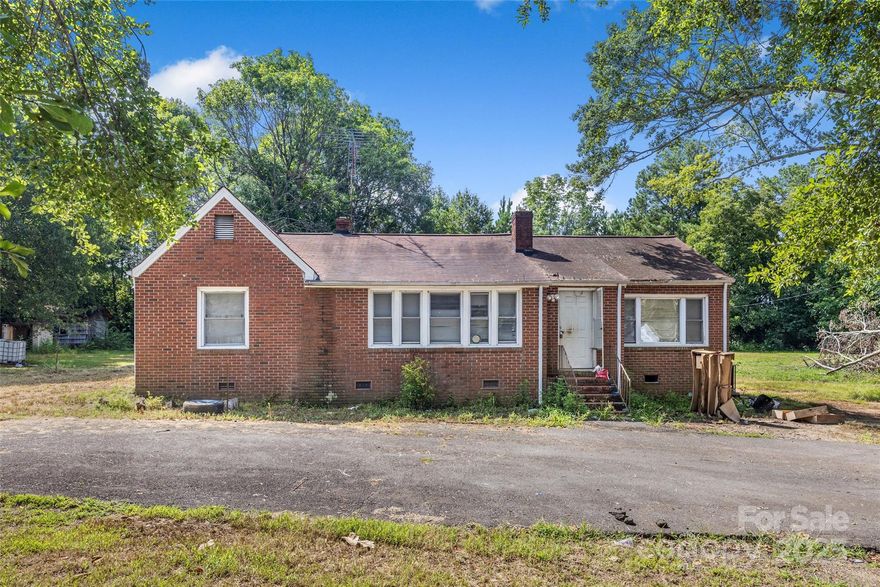 Investor, flipper, or handy homeowner with a vision — this one’s for you. In a prime location off Constitution Blvd with new homes being built just across the street, this property is packed with potential. This 4-bedroom, all-brick ranch sits on a huge 1-acre lot with circular driveway in an established, quiet neighborhood with no HOA. The home offers solid bones, a functional single-story layout, and room for customization inside and out. Whether you're looking to renovate and resell, create a long-term rental, or personalize it into your own dream home, the possibilities are endless. Conveniently located just minutes from I-77, downtown Rock Hill, local shopping, and dining. Ideal for investors, handymen, or visionaries looking to make their mark in one of Rock Hill’s rapidly growing areas. Sold as-is - bring your plans, your tools, and your imagination! Call now and let's talk!