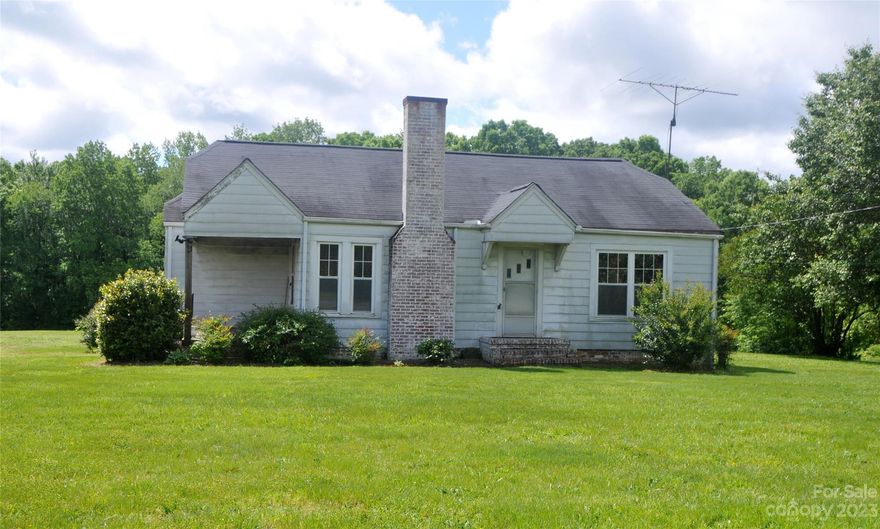 +/- 6.73 acres w/cute 2 bedroom 1 bath home needing new owner(s). The home has a large den, fplace w/electric logs; sizeable dining rm; separate area 4 laundry w/extra storage; & kitchen w/an outbuilding & old shed; & cellar. Beautiful land - country living and county taxes only. Approx 230' of road frontage on Hwy 152. Property being sold 'as is" - no known issues with the home.  Roof replaced 2014; Furnace replaced 2007; and compressor on AC replaced a few years ago. Cellar has sump pump and gets turned on when there is rain. Many years ago, gas station on the lot to left of property (and downgrade to this lot) -NC Dept of Environmental Quality tested water and all results good. Requested septic permit from Rowan County-they have no records, so classified number of bedrooms as 2 - tax records do not indicate # of bedrooms.  Appraised for $330K in July 2023.