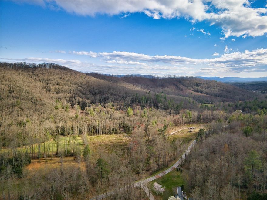 Virtual Tour. One of the last large unrestricted land tracts in Asheville. 51.4 Acres Zoned R-3. Suitable uses include Subdivision, Mobile Home/Tiny Home Parks, Hunting & Gun Clubs. Mostly mature hardwood & participates in a North Carolina Forest Management Program for deferred taxes. 10 acres have been timbered 3 years ago that could be reclaimed as pasture. 1,700+ feet of Merrills Creek running through it is believed to be native trout water. There are 6+ estate sized build sites offering pastoral, near range, layered long range southern & westward views. Asheville Airport, Biltmore Park & Arden shopping Conveniences are only 17 minutes away. Downtown Asheville’s Arts, Restaurants & Breweries are only a 16 minute drive. Whether you’re looking to move to the mountains or just need that weekend retreat, this mountain property is ready for you to build your dream home. Short Term Rentals permitted. Excellent Investment Property. Interactive (Matterport) Tour also available upon request