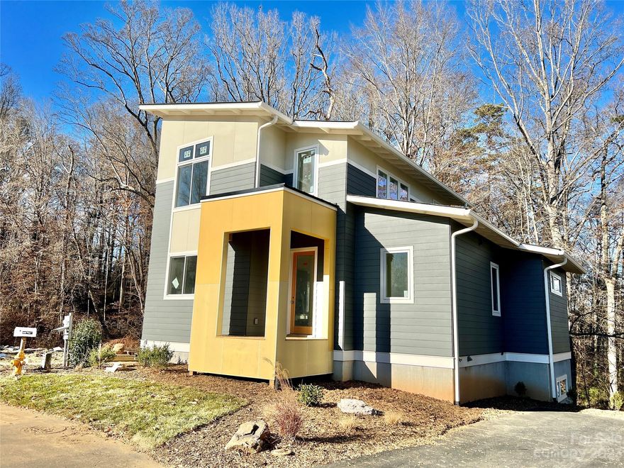 New Green Home (Under Construction) in Craggy Park with one of the best lots in the community. This modern home abuts the Falconhurst Nature Preserve with preserved woods behind the home that will never be developed!  Customized home in Craggy Park’s Second Phase includes higher-end finishes, a gas fireplace in the living room, and sunny primary bedroom suite on the main level that overlooks the nature preserve. Interior boasts a modern kitchen, white oak and polished concrete floors, higher-end Bosch appliances and designer-selected fixtures and vaulted ceilings on the second level. Excellent open plan by award-winning Wilson Architects. Be a part of this community with friendly eco-conscious neighbors and enjoy the walkability to both Haywood Road and on the trails behind your home. Enjoy picnics in the community's private park, fires in the neighborhood fire pit or gardening on sunny days in the community organic gardens. To be completed January 2024.