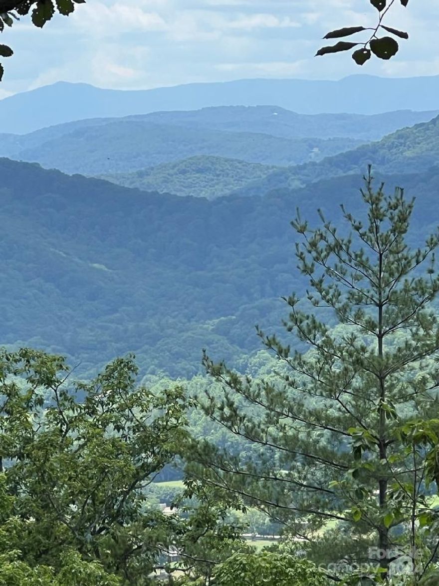 Views!! Views!! Picturesque long range views of the Black Mountains the highest points east of the Mississippi that includes Mt. Mitchell. Nearly two acre lot south and west facing giving you those gorgeous sunsets. Close range views of Honeycutt Mountain. Underbrush cleared revealing the topography for an easy walk at your showing. Terrain has just the right slope for your dream home that will accommodate a level driveway. Community allows vacation rentals. 10 minutes from Linville Falls, Linville Falls Winery and Blue Ridge Parkway. Centrally located 50 minutes to Boone and Asheville. 2 hours to Charlotte.