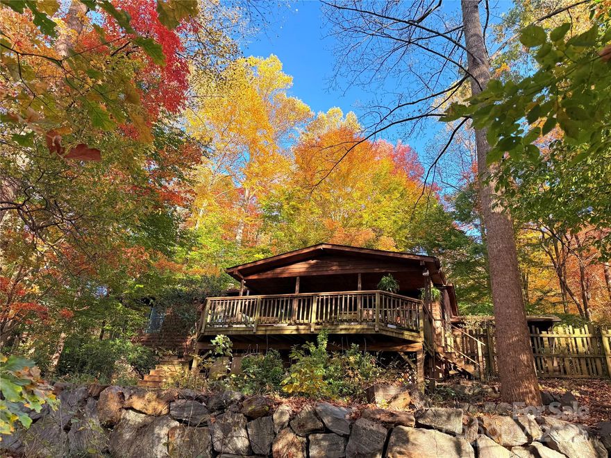 Welcome to your three bedroom two bath cabin in the woods on over an acre of land. This storybook retreat offers an open floor plan, beautiful hardwood floors, and a warm wood stove for cozy mountain evenings.



The gourmet kitchen features stainless steel appliances, granite countertops, custom cabinets installed by Ashleys Kitchens in Black Mountain, and a tiled floor. The primary bedroom includes a private bath and a sliding glass door that opens directly to the covered side porch. The third bedroom can also function as an office and includes French doors that open to the living room. The home offers a lovely winter mountain view and multiple outdoor spaces to enjoy the peaceful surroundings. The back porch is already wired for a hot tub or sauna.



Additional features include a two car carport and a workshop connected to the carport. Set on just over an acre, this property is a true nature oasis with wooded privacy, fresh mountain air, and the quiet beauty of the surrounding forest.



This peaceful location is just a five minute drive to downtown Black Mountain, where you’ll find charming shops, local restaurants, and a vibrant arts scene. Asheville is only fifteen minutes away, offering world class dining, music, breweries, and cultural attractions. Surrounded by the Blue Ridge Mountains, this area blends small town warmth with endless outdoor recreation. Come make this cabin in the woods your retreat in the heart of Western North Carolina.