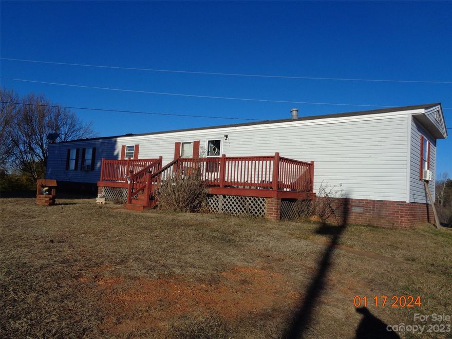 Singlewide mobile home with brick underpinning located in the country on corner lot in Kaylas Ridge subdivision. Convenient to highway 18 & South Mountains State Park. Detached double carport & storage building. Deck on front & back. Island in kitchen. Range, refrigerator & dryer included. Adjoining parcel for sale.