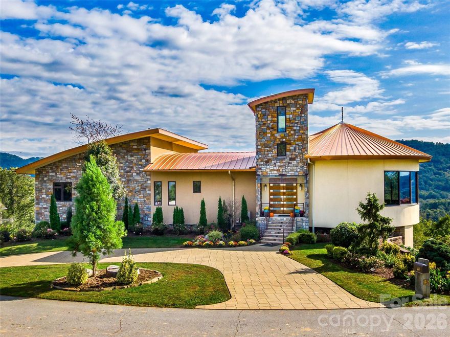 Modern Luxury with Panoramic Downtown Asheville and Long-Range Layered Mountain Views — Just Minutes to Downtown Asheville

Perched high above the city, 95 Horizon Hill Road offers what may be some of the most commanding views of downtown Asheville and the iconic Grove Park area. Built in 2017 and set on nearly an acre, this striking modern residence blends architectural strength, refined materials, and exceptional efficiency—all just 8 minutes from the heart of the city.

The home encompasses 5,329 total square feet, thoughtfully designed to frame sweeping mountain and city vistas from nearly every room. A solid Honduras mahogany front door creates a dramatic arrival experience, setting the tone for the craftsmanship throughout. Expansive Marvin windows and exterior sliding doors flood the interiors with natural light, while an impressive living room features floating steel beams that underscore the home’s modern structural elegance.

The chef’s kitchen is equipped with Sub-Zero refrigeration, a Wolf gas range, electric oven, and dishwasher, plus a large walk-in pantry with custom shelving. An additional refrigerator in the garage makes entertaining effortless.

Outdoor living is elevated with a 637 sq ft steel-framed rear deck and staircase, designed to maximize the breathtaking outlook. An outlook tower further enhances the experience, offering a rare vantage point over Asheville’s skyline and the surrounding Blue Ridge Mountains.

Built for longevity and peace of mind, the home features a metal roof with a 45–50 year lifespan, metal-wrapped fascia boards, 15.8 kW solar collectors, a 20 kW gas generator, and remarkably low annual electricity costs. Additional highlights include three central air systems, central vacuum, stamped concrete driveway, monitored security system with remote access, on-demand gas hot water heaters, and a gas fireplace.

A rare offering where city convenience meets elevated design, this property is a statement residence for those seeking Asheville’s finest views, modern infrastructure, and enduring quality.