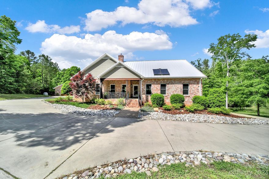 4500+ Sqft Home w/ Full Fenced 10+ Acre Lot w/i ~5 Min Of Dining, Shopping, & I-77. A Perfect Mix Of Country Living & Convenience! Recently Updated Kitchen, Laundry, & Added 300+ Sqft Owner’s Retreat. Extremely Well-Built Home w/ 50-Year Metal Roof, Reclaimed Brick, Antique Heart Pine Flooring, Custom Metal Railing, Spray Foam Insulation For High Energy Rating, Solid Core Doors, Interior Insulation For Sound Reduction, Energy-Efficient HVAC, Solar Panels, Fully Conditioned/Sealed Crawlspace & Dual 1000-Gallon Underground Rainwater Collection Tanks. Oversized Garages: 2-Car Attached & 2-Car Detached. Second Living Quarters w/ Kitchenette. Private ~0.75-Acre, Spring-Fed Pond. Whole Home Water Filtration w/ UV Light. Fruit Trees Recently Planted. Additional Unique Features Of This Custom-Built Home Attached. Enjoy Rock Hill School District w/ Choice Programs Incl Language Immersion, STEAM, & More!