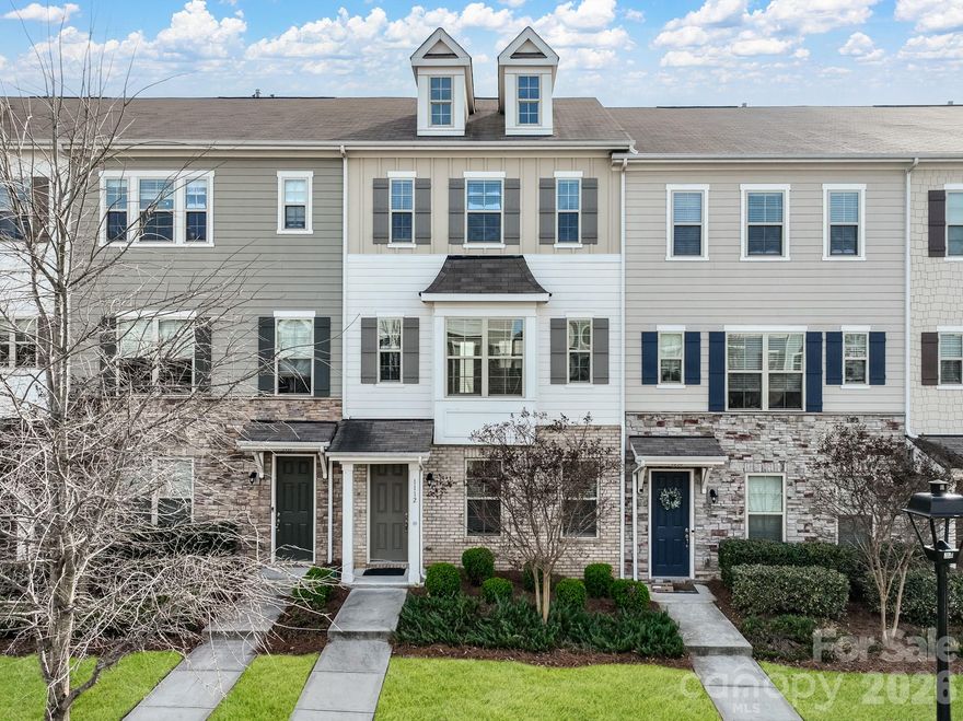 Discover the perfect blend of style and convenience in this stunning 3-story townhome, located just a short walk from the Arrowood light rail station. This 4-bedroom, 3.5-bath home features a versatile ground-floor guest suite and an expansive second-floor open layout designed for entertaining. The chef-inspired kitchen is a standout with its massive island, gas range, walk-in pantry, and stainless steel appliances, all leading out to a private balcony. Upstairs, the primary suite offers a luxurious retreat with trayed ceilings and a spa-like walk-in glass shower. Complete with an installed Tesla charger in the garage and access to a beautiful community pool and cabana, this home offers an upscale lifestyle just minutes from I-77, shopping, and dining.
Monthly HOA dues include lawn maintenance, trash, and recycling.  a