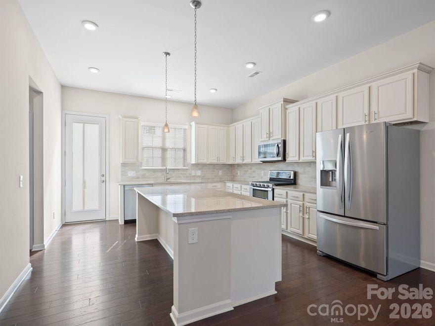 Discover the perfect blend of style and convenience in this stunning 3-story townhome, located just a short walk from the Arrowood light rail station. This 4-bedroom, 3.5-bath home features a versatile ground-floor guest suite and an expansive second-floor open layout designed for entertaining. The chef-inspired kitchen is a standout with its massive island, gas range, walk-in pantry, and stainless steel appliances, all leading out to a private balcony. Upstairs, the primary suite offers a luxurious retreat with trayed ceilings and a spa-like walk-in glass shower. Complete with an installed Tesla charger in the garage and access to a beautiful community pool and cabana, this home offers an upscale lifestyle just minutes from I-77, shopping, and dining.
Monthly HOA dues include lawn maintenance, trash, and recycling.  a