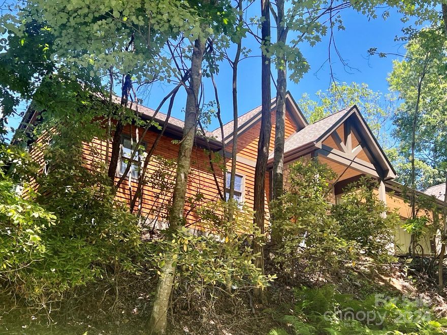 If you are looking for a view house, this is it! 145 Udoque Court has magnificent, long range, year-round views. This custom home boasts an extraordinary great room with a beautiful stone fireplace. It has stunning wood floors, leathered granite, GE Cafe appliances, 8 foot doors, and exquisite attention to detail throughout. The luxurious primary bedroom has a tray ceiling, huge walk-in closet with built-ins, and a gorgeous primary bath. Downstairs you will enjoy a large family room, 2 bedrooms, and 2 full baths. Outside you will love the expansive stonework, covered front porch, rear decks on both levels, and an attached garage. This is the ultimate mountain home where you will enjoy phenomenal, everchanging views of the surrounding Blue Ridge Mountains. All of this and it is nestled in the highly desirable Connestee Falls, a gated golf course community which offers extensive amenities, and it is located only a short distance from all the attractions of downtown Brevard.