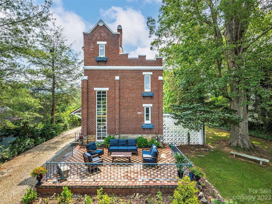 Standing tall in downtown Weaverville, this eye-catching gothic stunner complete with flying buttresses and a parapet awaits its playful buyer! Designed by Scottish architect Lorin A. Rawson and masterfully renovated in ’22, "Rhododendron Hall" combines iconic architecture w/ all the conveniences of modern-day living: a new kitchen, new baths w/ designer tile, gorgeous fixtures, new paint & hardwood floors throughout. New mini-splits on main and upper levels. On-demand water heater. Finished basement w/ bath showcases grotto-like rock walls and alluring mosaic slate/flagstone floors. The uppermost floor offers an office w/ mtn views. A paradise for gardeners, the expansive yard features towering hardwoods and a grassy level front yard. Like to entertain? The whimsical checkered terrace is the perfect backdrop for a Great Gatsby-themed shindig or the spookiest Halloween party! Ready for a night out? Take the sidewalk to restaurants, coffee shops, breweries & galleries! STRs are allowed.