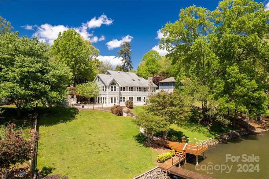 Immerse yourself in the epitome of lakeside luxury at this fully renovated waterfront sanctuary on Lake Wylie. Set upon 1.2 acres of picturesque landscape, this property boasts deep water access right off the dock, perfect for indulging in water sports or simply enjoying the serene views. Entertain in style in the gourmet kitchen, equipped with top-of-the-line appliances and custom cabinetry. Retreat to the luxurious primary suite, offering a private sanctuary with stunning water views and a spa-like ensuite bath. Additional bedrooms and baths ensure plenty of room for guests to feel at home in this lakeside paradise. Step onto the expansive patios and be greeted by the warmth of an outdoor fireplace, ideal for cozy gatherings under the stars. A waterfront splash pad adds to the fun! Whether you're seeking relaxation or adventure, this meticulously updated retreat offers the perfect blend of comfort and sophistication against the stunning backdrop of Lake Wylie's tranquil waters!