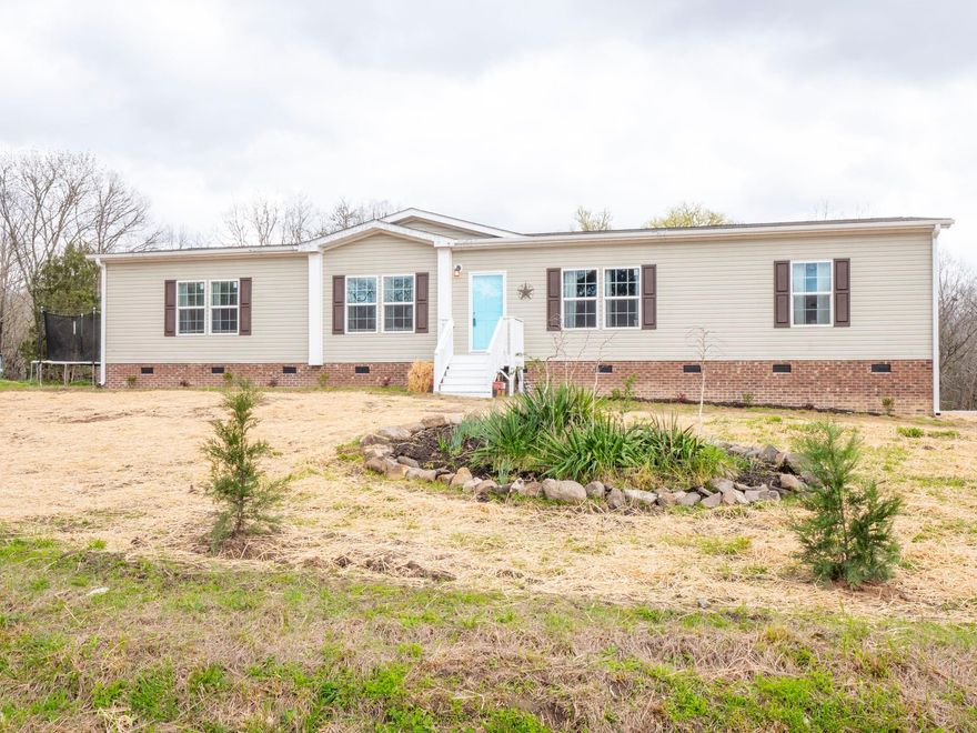 If you're looking for modern living in a private country setting WITH acreage- look no further! Manufactured doublewide on 5 acres with abundant privacy on a wooded backdrop. Spacious open floorplan, with tall ceilings throughout the home. The primary suite features an ensuite bath with an oversized tub- separate walk-in shower, and large walk-in closet. Kitchen boasts an oversized island with seating, adjoining the dining and living area. 3 large bedrooms and a sunroom that has been enclosed and is currently being used as a 4th bedroom. Less than one mile from the Herbert Kirsh Wildlife Conservation Area, and less than 2 miles from the McConnells Tract Wildlife Management Area..