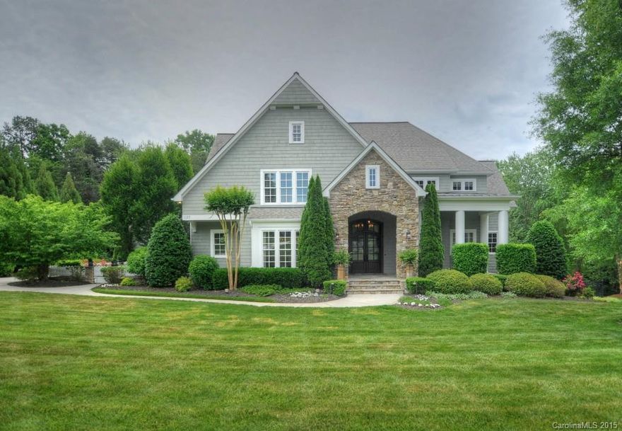 Beautifully custom designed and decorated for elegant yet comfortable living. Situated on the 10th fairway of Trump Nat'l Golf course. A deeded boatslip for lake enjoyment, a fabulous covered rear porch with fireplace for year round outdoor entertainment. Stunning interior has limestone and marble countertops throughout, chef's dream kitchen, butlers pantry, library style dining room, main level master suite, 5" hardwood flooring and a lower level billiards area. The wow factor!