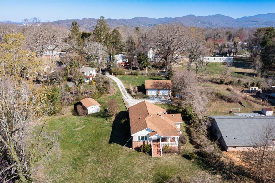 MULTIPLE OFFERS RECEIVED!!!!  WILL BE CALLING FOR HIGHEST AND BEST BY 5:00PM ON FRIDAY MARCH 24TH. DON'T MISS THIS AWESOME PROPERTY IN SOUTH ASHEVILLE.  So much potential on an oversized lot, two detached garages for amazing storage or potential expansion (buyer to confirm).  Home has great bones with a country kitchen, breakfast bar, open beams in living room with fireplace & gas logs.  Home needs some new carpet & paint, but you can't beat the location.  Outside chimney oven for wonderful outdoor living.