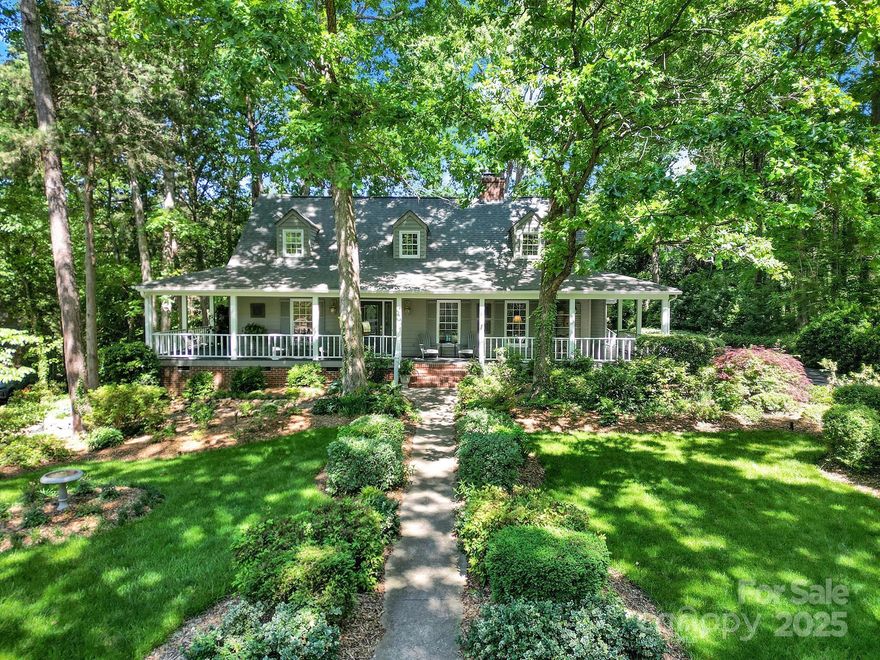 Located in the gated golf community of River Hills on Lake Wylie, this home with an incredible wrap-around porch sits on a quiet dead-end street, backing to green space near the shoreline and community garden. Inside, an impressive double-sided fireplace is between the dining room and living room and the family room with vaulted ceilings, skylights, bar, and a fireplace is connected to the gourmet kitchen with bay window seating and the breakfast nook. The primary suite is located on the main level, and a side-load garage adds to the home’s functionality. This property combines a peaceful setting with access to extensive community amenities including a marina, an 18-hole golf course, clubhouse with dining, two pools—including one with a Tiki bar—tennis courts, a dog park, playgrounds, and miles of walking trails. The neighborhood also features a lakeside park with a sandy beach and gazebo, as well as 24/7 security and gated entry.