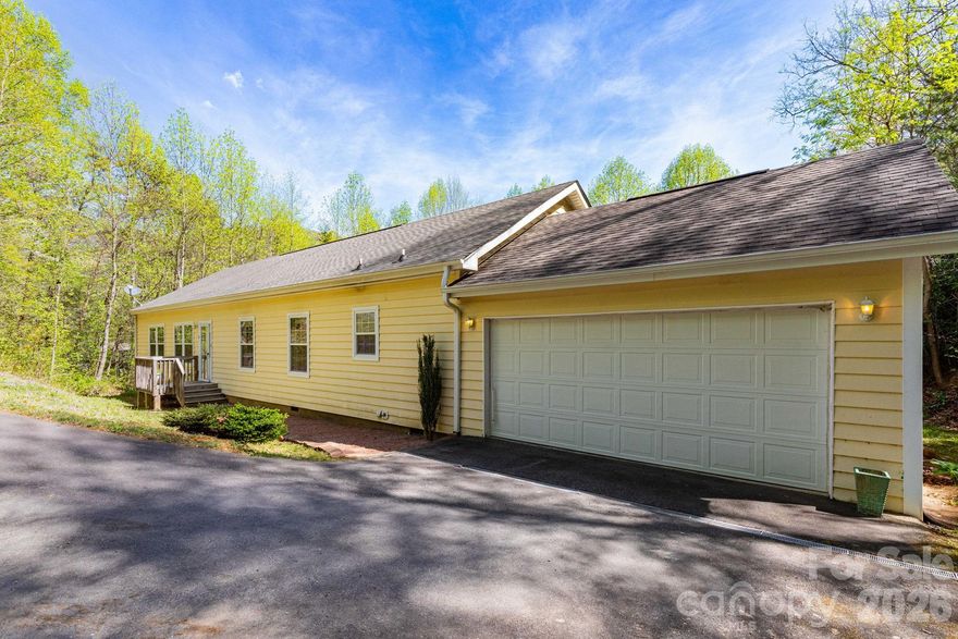 Welcome home to easy, single-level living in the heart of Candler! Set on a generous 1.38-acre lot in the quiet Ruth Villa neighborhood, this beautifully maintained 3-bedroom, 2-bath home offers the perfect blend of comfort, space, and natural beauty.

Inside, you’ll find an inviting layout with both a living room and a cozy den featuring a gas log fireplace—ideal for relaxing evenings. The spacious eat-in kitchen shines with abundant cabinet storage, tile backsplash, stainless steel appliances, a pantry, and a center island with additional storage. A sunny breakfast nook and built-in desk create the perfect spot for casual dining or a convenient home office. Step outside to the large back deck, perfect for entertaining or enjoying peaceful mornings surrounded by nature.

All three bedrooms offer walk-in closets, and the primary suite includes a private ensuite bath. A dedicated dining room, 2-car garage, and excellent condition throughout make this home truly move-in ready.

Outside, the property truly shines with a beautiful backyard featuring a nature path, mature rhododendrons, and established trees—creating a private, serene setting.

Just 2 miles to Hwy 191/Pisgah Highway with easy access to the Blue Ridge Parkway. Only 10 minutes to Enka/Candler shopping and dining, and 25 minutes to downtown Asheville.

Enjoy quiet neighborhood living with room to roam, all while staying close to everyday conveniences and outdoor adventure.

Schedule your showing today or reach out to learn more about this special property!