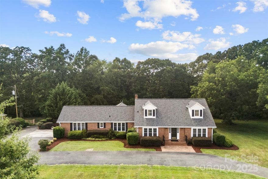 **Location and Space!** This stunning all-brick home features 5 beds & 4 baths, located in the award-winning Clover School District. Upon entry from the large circular driveway, you are welcomed by a two-story foyer leading into a living room filled with light. The dining room, situated between the kitchen & living room, makes it ideal for hosting. The spacious kitchen, complete with a bay window, opens to the den, a two-car attached garage, full bathroom, & tiled mudroom with laundry facilities. Upstairs, you’ll find 3 well-sized bedrooms with 2 full baths. The unfinished basement offers potential for additional living space. The property includes an all-brick wired workshop with a concrete floor, a walk-through door, and roll-up door for convenience. Outside, the screened-in porch overlooks a fenced backyard, providing the perfect spot to sip morning coffee while admiring the 5.5 acres of tranquility. You will also find a custom brick patio area surrounded by beautiful landscaping.