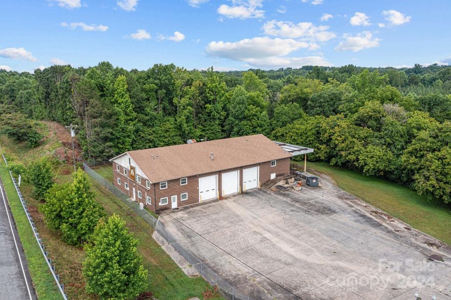 This prime commercial facility in Salisbury, NC offers easy access and high visibility from I-85. Built in 1980, the facility spans over 8,800 sq. ft. and is ideal for commercial vehicle repair, warehouse operations, offices, parts rooms, and more. Key features include an outdoor covered wash bay, an oil changing pit, ample storage, and multiple tool/parts rooms. The upstairs office overlooks the open shop area, which includes three drive-thru 14-foot bay doors. The facility also boasts over eight designated office spaces, six restrooms, and a kitchen/lounge area. This versatile and well-equipped space is perfect for businesses needing a comprehensive workspace with convenient interstate access. Conveniently located 30 miles north of Charlotte and 40 miles south of Greensboro, NC.