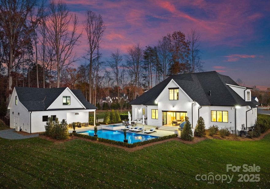 Situated on 1.49 acres of prime Lake Norman waterfront in Saylors Watch, this estate offers unparalleled luxury & privacy. The home features 5 generously appointed bedrooms, each w/ its own ensuite, plus a cabana bath. The primary suite is a retreat of its own, w/ a spa-inspired 5-piece bath & bespoke walk-in closets. The gourmet kitchen boasts a Lacanche gas range, marble countertops, & a True commercial fridge, complemented by a scullery equipped w/ a True wine fridge. Outdoors, discover over 200' of shoreline, a sandy beach, & a heated saltwater pool & spa set amidst Turkish sandblasted marble decking. A shared dock w/ a lift & lake-fed irrigation enhances the waterfront appeal. Entertain effortlessly with a Piombo pizza oven, Tec grill, & retractable screened patio w/ fireplace. A 5-car garage includes a detached 2-car space w/ a private guest apartment above that is well equipped, while media & fitness rooms, two offices, & lush landscaping complete this exceptional property.