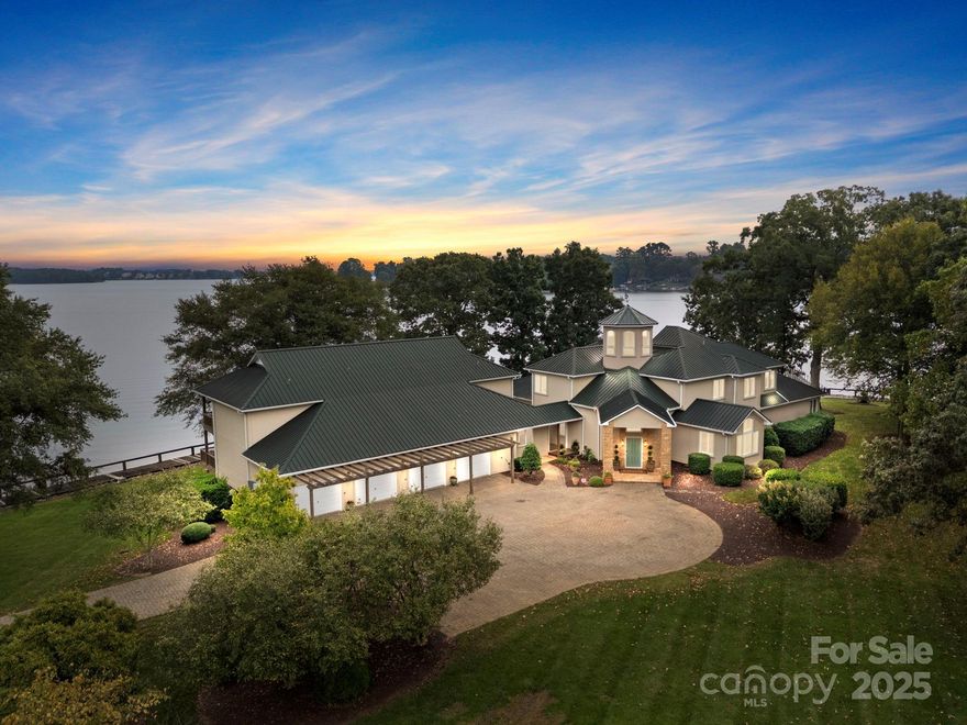 PARADISE FOUND! Welcome to 1890 Yacht Club Drive. This 2.8 acre point lot includes a thousand feet of  shimmering Lake Norman shoreline. Resort style living at its best. This estate is simply the crown jewel of Lake Norman. Begin your mornings with sunrises over the lake and end your evenings with spectacular sunsets watching sailboats finding their way home. This one of a kind estate is being offered for the first time ever. The compound includes the main home, three attached townhomes and a spacious sailing club property with over one hundred and twenty boat slips. The main home includes four bedrooms and three and a half bathrooms. The three townhomes include a total of seven additional bedrooms and four full baths. The sailing club structure offers a meeting room, two bedrooms and three full baths. This distinctive property allows for both connection and privacy for friends and guests. Perfect setting for a corporate retreat or multigenerational living .The  main home boasts stunning architecture where luxury and high functioning comfort blend seamlessly. Highlights include an open modern floorplan with two-story stone fireplace, soaring wood ceilings, and a spacious sitting room with one hundred eighty degree Lake Norman views. The rooftop terrace offers a panoramic three hundred sixty degree view of the shimmering waters of Lake Norman. The spacious primary suite offers privacy, lake views, a hidden safe room, and luxurious bath with dual closets. baths, and a loft. A rare boardwalk surrounds the waterfront edges of the property. Lush landscaping and expansive patios gives this enclave show stopping outdoor living.   Simply the most serene and beautiful property on Lake Norman. Please do not miss this once in a lifetime opportunity.  This property is being sold with adjacent parcel  ...1887 Yacht Club Road.