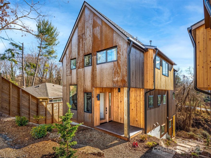 Fresh, modern, and thoughtfully designed—this newly built Scandinavian-inspired home blends clean architecture with warm, natural materials. Corten steel and cypress siding create a striking, low-maintenance exterior, while inside, light-filled spaces and an open floor plan set the tone for easy living. Designer tile, custom cabinetry, elevated fixtures, and a cozy wood stove add texture and depth without sacrificing simplicity.

Set in the heart of Montford—one of Asheville’s most desirable neighborhoods—you’re just minutes from downtown, the River Arts District, local galleries, and acclaimed restaurants, yet tucked into a peaceful residential setting.

The layout includes 4 bedrooms, 3.5 bathrooms, a dedicated flex or office space, and a second living area, offering flexibility for work, guests, or everyday comfort. The fully finished daylight basement features a private entrance, wet bar, and stackable washer and dryer—ideal for multigenerational living, a guest suite, creative studio, or potential short-term rental use (buyer to confirm).

Next door, 171 Houston Place (MLS #4335456) is also available. Both homes were designed by All Clear Design and built by Green Light Custom Homebuilders, presenting a rare opportunity to purchase side-by-side new construction with matching quality and design.

Custom-level craftsmanship—without the custom process.