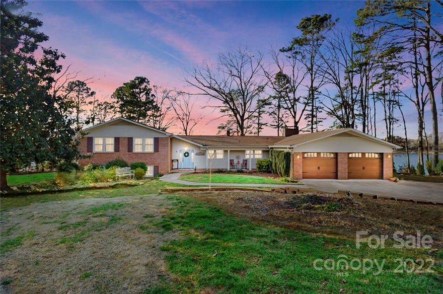 Waterfront charmer with panoramic views. Come ready to play at one of the best main channel locations Moss Lake has to offer.  Home offers 4 bedrooms, 3 full baths and 1 half bath.  On the main level you will find an oversize eat in kitchen, dining room/office, great room, family room, oversized laundry room and half bath. Upper level has the primary bedroom and bath, three additional bedrooms and full bath. On the lower level there are two bonus rooms, full bath, rec room and additional small kitchen.  Walk out into your screen porch and relax and enjoy the lake.  You’ll never lack for space to host gatherings.  Outdoors you have a deck, two firepits and new dock. Enjoy the incredible sunset views. New HVAC on Main level.  Location is very convenient to Charlotte.  30 minutes to CLT airport, less than 10 mins to Hwy 74.