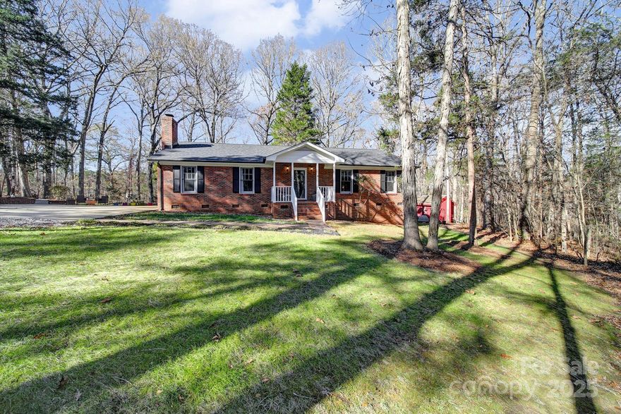Beautiful all-brick home on 5.00 acres in Fishing Creek Farms located at the end of a quiet dead-end road. Home backs up to a large tract of land currently protected under a land conservancy. Neighboring properties are like-kind single-family homes on 5+ acres. Enjoy the expansive deck with gorgeous wooded views. Living room has vaulted ceiling with floor-to-ceiling stone fireplace. All bedrooms have extra large closets. Beautiful landscaping with trails in the back of the property. Wired workshop with workbench. Outdoor electrical outlets installed. New storage shed with built-in shelving and attached dog kennel with building access can also be used as a chicken coop. Pull-down indoor stair attic access has plenty of storage. 2025 HVAC, fresh paint inside and out, and refreshed crawlspace with new insulation and vapor barrier. High-speed fiber optic internet connected to the home. Fruiting pear and apple trees on the property. U-pick blueberry farm is right around the corner. Huge cement parking pad is perfect for RVs, multi-vehicle parking, trailer, you name it! No HOA! Located just minutes from I-77!  Move in now and start enjoying peace and quiet in the country!