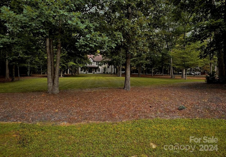 The best of both worlds…a neighborhood and land. This beautiful completely remodeled inside and out designer home sits on 2 1/2 acres in sought after Marvin Ridge School district. The kitchen is a dream with an oversized island with quartz countertops, soft close drawers, induction cooktop and beverage area. Enjoy the convenience and beauty of this gourmet kitchen with new GE Cafe smart appliances. Forget to turn the oven off, or want to preheat the oven on the way home, it’s no problem with its easy to use app. Stunning special touches through out this home like the see through 55 inch fireplace between the kitchen and living area, featured accent walls and unique inlay on kitchen island. There is also an office/exercise room or flex area with tall glass doors downstairs and a bonus room or flex area upstairs. The large primary suite looks out over the treetops with 5 large windows across the back and the spa-like primary en-suite will be a favorite.