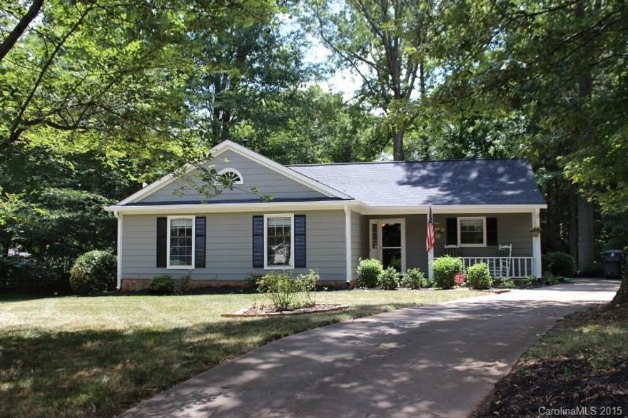 Adorable ranch home w front porch convenient to shopping, restaurants & more! 3 bedroom, 2 full bath. Beautiful granite counters & tile backsplash, new faucet & updated appliances. Sunny dining area. Renovated fireplace w new gas logs. Hardwood flooring. Enjoy private mature landscaping. New roof 2014. New AC unit 2011. Updated master bath with travertine tile/shower. Private deck entrance from master. Exterior paint 2014. Repainted huge deck 2014. $1000 carpet allowance with acceptable offer.