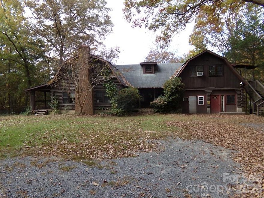 Back on market with an extra Manufacture Home and 1/2 acre homesite.  Large Log Home on 7.38+/- Acres with nice pond.  Property has metal shop, carports, storage sheds and two old mobile homes (Not Livable).  Pond has small island ideal for waterfowl.  Land is already in 5 tax maps being offered altogether.  Home is being sold "as is".  Great for small farm or family compound near the conveniences of Indian Land SC & Charlotte NC.  Great opportunity for developer or builder.