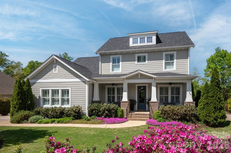Welcome to this exceptional home in one of Fort Mill’s most desirable neighborhoods - SPRINGFIELD, where charm, space, and thoughtful design come together beautifully. From the moment you arrive, the inviting Southern-style rocking chair front porch sets the tone for relaxed, elegant living. Nestled on nearly half an acre, this wooded homesite offers privacy and scenic views as it backs directly to the golf course. A spacious three-car garage provides ample storage and convenience. Inside, the open-concept main level is filled with natural light, highlighted by a dramatic wall of windows, soaring ceilings, and a cozy fireplace—creating the perfect setting for both everyday living and entertaining. At the center of the home, the chef’s kitchen is sure to impress, featuring a large granite island, SS appliances, wall oven & microwave, gas cooktop, and a generous walk-in pantry.
The primary suite on the main level serves as a peaceful retreat, offering serene views of the private backyard. Upstairs, you’ll find three additional bedrooms, a spacious loft, and a versatile bonus room— all offering ample flex space for family, guests and recreation. Additional highlights include pre-finished hardwood flooring throughout main level, a dedicated office/formal living space, extensive moldings and an encapsulated crawl space. Step outside to enjoy the stunning oversized screened porch, ideal for year-round relaxation, along with a beautifully designed patio and stone fire pit area—perfect for gatherings under the stars.
**Recent updates provide added peace of mind, including a new roof (October 2023), first-floor HVAC (August 2024), and second-floor HVAC (October 2024).

Springfield Community is Amenity Driven: Clubhouse; Fitness center; three pools; Activities Director; Pocket Parks; Tennis Courts and Pickleball courts (currently under construction); 18 hole Public Golf Course; 
Annual GenAdmission to Anne Springs Greenway, Playgrounds, Recreation areas, sidewalks/street lights throughout and so much more. This meticulously maintained home offers a rare opportunity to enjoy comfort, style, and an unbeatable private non pass through street location. Don’t miss your chance to make it yours:)