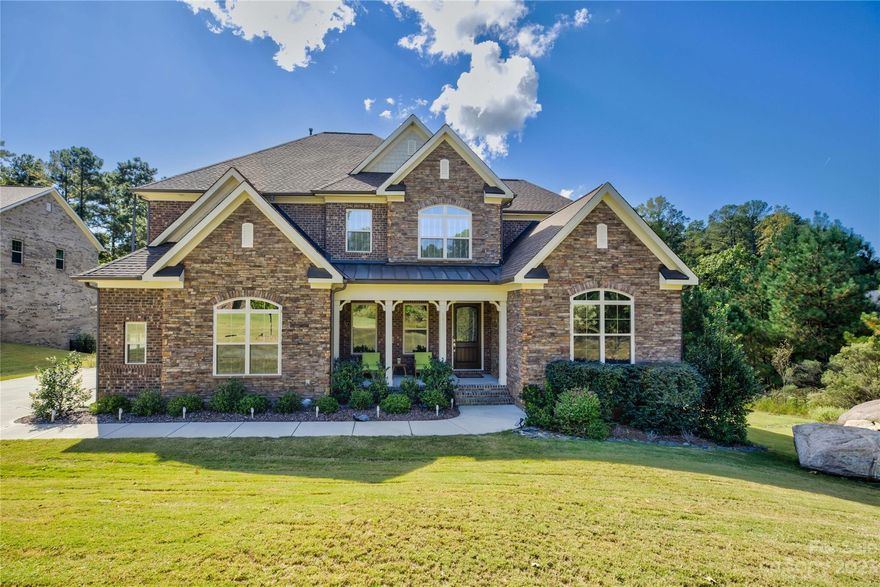 Perfectly situated on an expansive cul de sac lot in the gated Bear Creek neighborhood at the amenity-rich Palisades, this full brick home is sure to impress. The formal dining room just off the foyer has rich wainscoting, coffered ceilings & a butler's pantry—and a main floor guest suite with en suite bath. Private office with French doors opens onto the side screen porch. The gourmet kitchen has a gas cooktop, oversized granite island, gleaming white cabinetry & tile backsplash. The sun-drenched breakfast area is surrounded by windows that continue into the fireside great room and open onto the expansive back deck and large private yard surrounded by woods. The spacious 2nd-floor primary suite offers a sanctuary with its dual closets, vanities, a soaking tub, and a glass-enclosed shower. Bdrm 2 has an adjoining bath, and Bdrms 3 & 4 share a buddy bath. A loft & laundry complete upstairs. 2 car & separate one car/hobby garage. Luxury living at its finest.