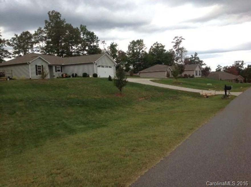 Immaculate home in pristine condition on nearly .8 acres! Home lovingly cared for. Marble counter tops in baths, granite tops in the kitchen, stainless steel appliances, gas FP, vaulted GR ceiling, fans in BR's & great room, storm doors, beautiful landscaping in back yard, & front walkway, 12 x 12 screened porch w/paddle fan, could be finished for an additional 137 HSF, extra parking pad, service door in garage and sidewalks to back yard, shed is negotiable. Very secluded & private back yard.