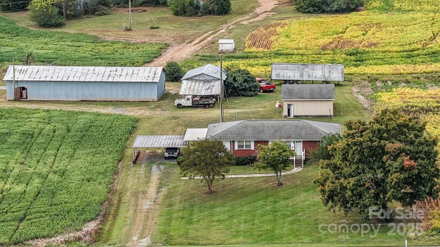 The great county living life in rural Marshville is waiting on you with easy access to major highways such as Hwy 74 and Monroe Expressway. This property and the buildings were built by one of the farmers in the Marshville area. Where else can you find a building like this with 5 bay roll up doors and one sliding door.? Detached garage plus additional buildings.  The home has central heat and air. Much of the home's interior is original but well maintained. This tract of 3.3 acres is part of a larger tract and has been surveyed. There is a small portion of the land that has a crop on it and hat remains the ownership of the farmer until this crop is harvested by the end of the year.
Tax value has not been determined with new survey