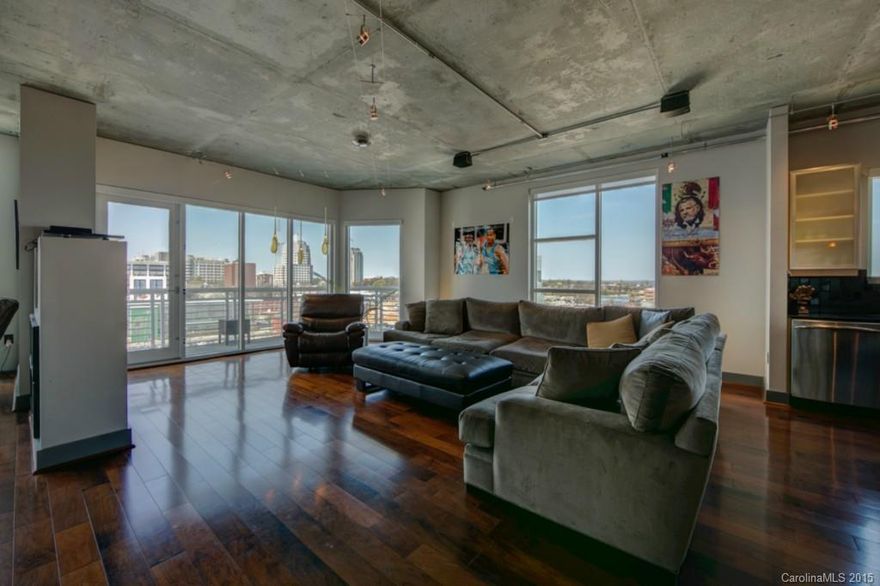 Stunning corner unit in Courtside!!!!  One of the best skyline views in the city.  Gleaming hardwoods throughout, award winning kitchen design and front row  view of the new First Ward Park and Time Warner Arena.  This immaculately maintained condo includes finishes not found in similar units.  Add to that, the convenience the location provides:  minutes walk to Epicenter, Arena Events, restaurants, museums and easy access to the interstate.  Gated, secure parking garage with 2 parking spaces.