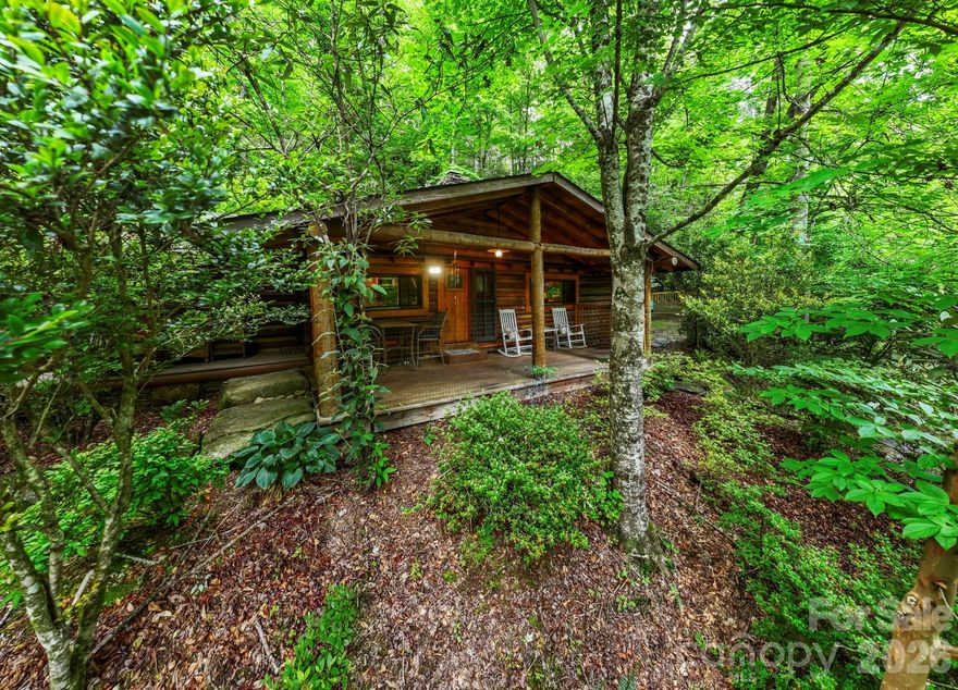 Welcome to your dream mountain retreat. This charming, fully remodeled log cabin is nestled on nearly 12 acres of unrestricted riverfront property, offering the perfect blend of rustic character and modern comfort. Inside, you’ll find warm wood finishes, a cozy sleeping loft for additional guests, and a thoughtfully updated kitchen featuring new appliances. Every detail has been designed to preserve the cabin’s timeless appeal while enhancing everyday livability. Outdoors, the setting is nothing short of extraordinary. Bordered by the serene Middlefork River and surrounded by breathtaking mountain views, the property has been lovingly cultivated for over 40 years. Enjoy lush, established gardens, a certified natural spring, a gravity-fed water feature, a picturesque waterfall flowing into a private trout pond, and an enchanting koi pond just behind the cabin. Relax on the porch with your morning coffee as you listen to the soothing sounds of cascading water over stone. With additional homesites ready for expansion and utilities already in place, this property offers exceptional flexibility and future potential. Whether you envision a private estate, family compound, or investment opportunity, the possibilities are endless. A strong long-term rental history of $2,850 per month adds to its appeal. Located just 10 minutes from downtown Brevard, you’ll enjoy convenient access to shopping, dining, and outdoor recreation while still feeling worlds away. This is more than a home—it’s a mountain lifestyle waiting to be yours. Duplicate MLS listing # 4352071