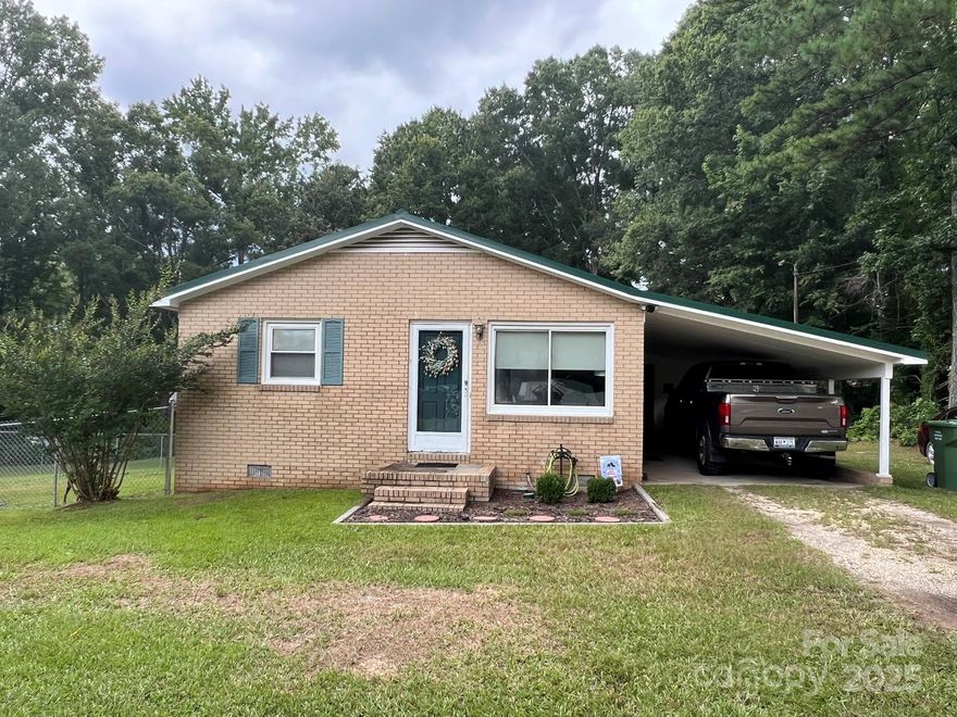 Looking for peaceful country living with easy access to city amenities? This charming 2-bedroom, 1-bath home offers the perfect blend of comfort, privacy, and convenience. Situated just outside the city of Lancaster, this well-maintained home is also centrally located between Columbia, SC and Charlotte, NC — making it ideal for commuters or those who enjoy weekend trips to either city. Inside, you’ll find a cozy and functional layout that’s easy to maintain. Outside, enjoy the large fully fenced backyard — perfect for pets, gardening, or entertaining — along with an attached carport and outdoor utility storage for tools, equipment, or hobbies. The 1-acre lot offers plenty of room to grow, relax, and enjoy the peace and quiet of this serene setting.