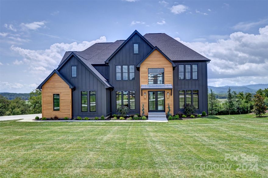 Stunning new build in The Farm at Mills River. This 5 bedroom/4.5 bath home features a grand two-story foyer.  The light filled great room features a two-story wall of windows with views of green fields and beautiful mountains. It boasts a two-story fireplace with natural gas logs. The kitchen is a gourmet’s dream with a 48” Sub-Zero refrigerator, 48” Viking natural gas range, Viking dishwasher, Viking microwave drawer, an 8-foot island, and abundant custom cabinetry. Quartz counter tops are utilized throughout. The primary bedroom features a back-lit tray ceiling, a sitting area, and large walk-in closet. The en-suite bath is abundantly appointed with a beautiful glass shower, free standing tub, and private water closet. The impressive upper-level catwalk is open to the great room and foyer below. This home has a spacious 3 car garage, and site finished hardwood floors.