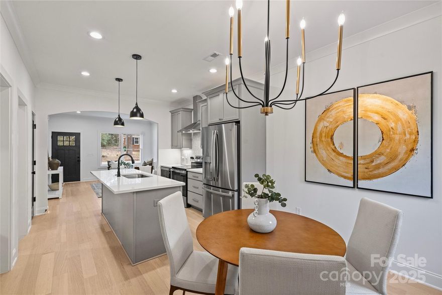 Quality construction comes to the Camp Northend area! Enjoy the abundance of natural light. The attention to detail w real hardwood floors & classic finish choices. This thoughtfully designed kitchen includes quality cabinets w slow close doors & no detail overlooked w choices like exterior vented hood.Spacious dining area and living room create ideal open layout. Perfect for entertaining, features bar area bar w convenient beverage fridge to keep your guests refreshed, w additional cabinetry for storage. Upstairs, you'll discover a tranquil primary bedroom. The primary bathroom showcases quartz countertops, framed mirrors & a vanity light that lends classic appeal. A full tile shower w frameless glass & storage nooks. The custom-designed primary closet ensures max storage space. The second floor also includes 2 secondary bedrooms, a guest bath, &  laundry space. Design details, such as the drop zone for easy organization near your garage. The best feature is the spacious, fenced yard.