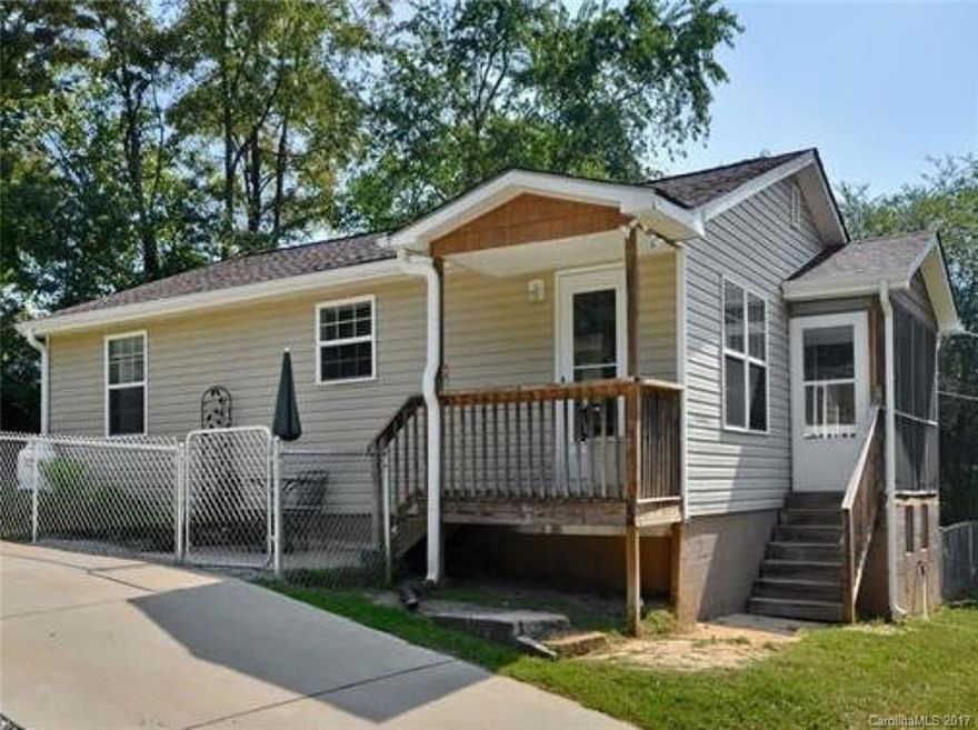Surrounded by 5 acres of pasture & 3 miles from downtown, you'll love this completely renovated charming west Asheville bungalow. New appliances in 2011, new septic in 2014, new roof in 2017. Custom built-ins & trim throughout. Beautifully refinished original hardwoods.  Immaculate, airy & bright with beautiful vintage lighting. Screened in front porch with custom built seating, fenced yard for pets, and room for gardening, with concrete pad in place for greenhouse, shed, or additional parking.